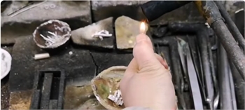 Using ancient techniques, primitive silver material after melting is made into a ring